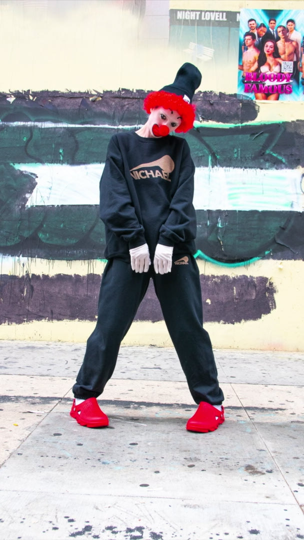 Load video: Clown dressed up in NICHAEL black basics set.